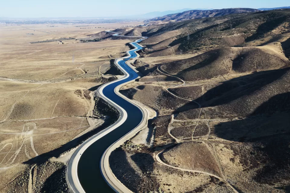 Aerial view of California aqueduct snaking through arid hills outside Los Angeles